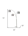 74" Brass Three Light Arc Floor Lamp With Off White Fabric Drum Shade