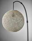 77" Antiqued Bronze Arched Floor Lamp With Groovy Beige Abstract Wicker Globe Shade