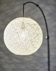 77" Antiqued Bronze Arched Floor Lamp With Groovy Beige Abstract Wicker Globe Shade