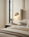 One Light Gold Wall Sconce with Round Glass Shade