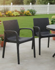 Set of Two Black Faux Rattan Heavy Duty Plastic Outdoor Stacking Arm Chairs