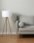 Gold Metal Adjustable Tripod Floor Lamp With White Linen Drum Shade