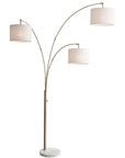 74" Brass Three Light Arc Floor Lamp With Off White Fabric Drum Shade
