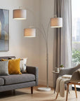 74" Brass Three Light Arc Floor Lamp With Off White Fabric Drum Shade