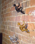 Set of Two Gold Resin Climbing Man Hanging Dimensional Sculpture
