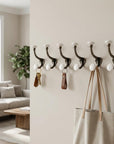 Set of Six Bronze And White Cast Iron And Ceramic Double Wall Hooks